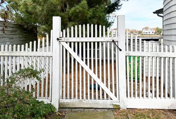 A Wood Gate And Picket Fence