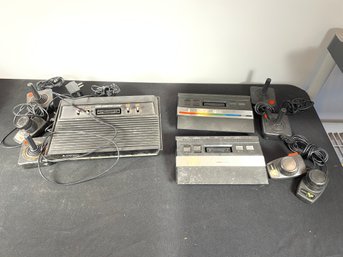 ATARI 2600 CONSOLE WITH CONTROLLERS AND TWO OTHER ATARI CONSOLES