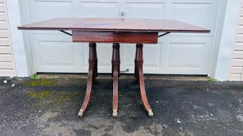 1940's Duncan Phyfe Triple Pedestal Drop Leaf Table With Brass Claw Feet