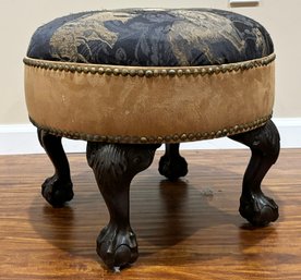 A Vintage Footstool With Elephant Themed Upholstery And Nailhead Trim