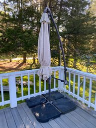 A  9 Ft Hanging Outdoor Patio Umbrella With Weights