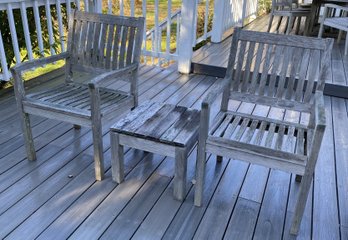 A Weathered Teak Wood Pair Of Chairs With Side Table By Gloster