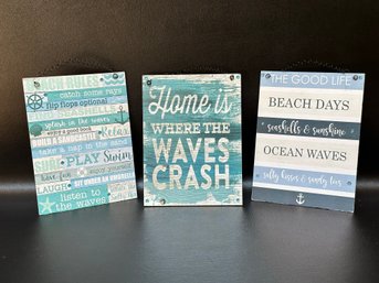 A Set Of Three Coastal-Themed Wall Plaques