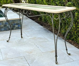 A Console With Travertine And Inset Glass Top And Wrought Iron Base