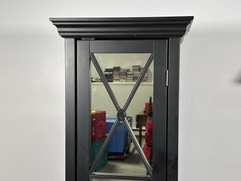 A Tall Cabinet With Mirrored Front & Interior Shelves