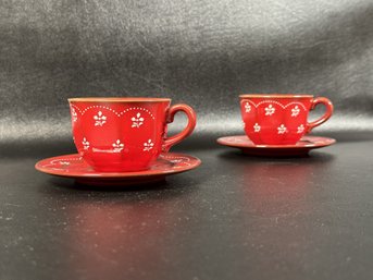 A Pretty Pair Of Vintage Ceramic Cups & Saucers In Red With A White Floral Design