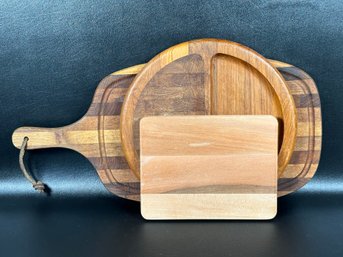 A Group Of Wooden Cutting Boards In Varying Styles