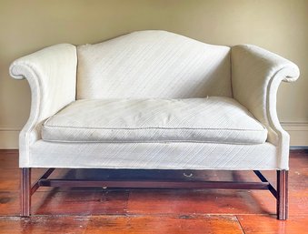 A Vintage Camel Back Loveseat With Down Cushion