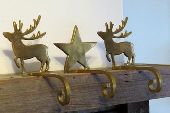 A Set Of 3 Brass Stocking Holders