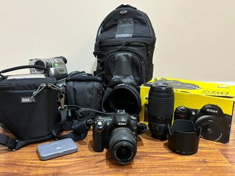 A Nikon Camera, Lenses, And Other Photo And Video Accessories