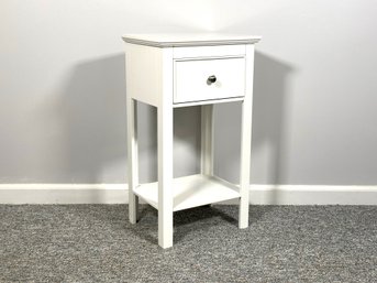 A Small, Simple Nightstand In White