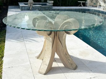 A Reed And Travertine Based Dining Table With Scalloped Edged Glass Top