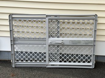 An Adjustable-Width Child/Pet Gate In Plastic