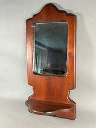 A Vintage Wooden Mirror With Shelf