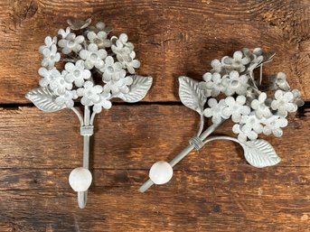 A Pair Of Metal Wall Hooks With A Hydrangea Design