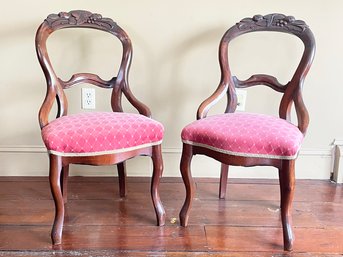 A Pair Of Victorian Balloon Backed Parlor Chairs In Carved Mahogany