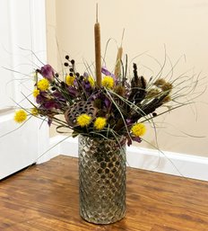 A Large Mercury Glass Vase With Faux Floral