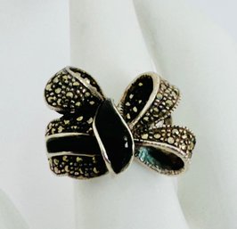 PRETTY SIGNED STERLING SILVER ONYX AND MARCASITE BOW RING