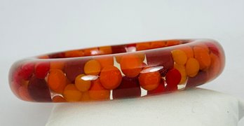 VINTAGE LUCITE POLKA DOT/ASPIRIN ORANGE/REDYELLOW BANGLE BRACELET