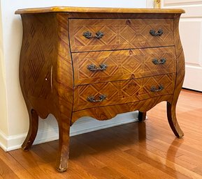 A Bombe Form Chest With Marquetry Front