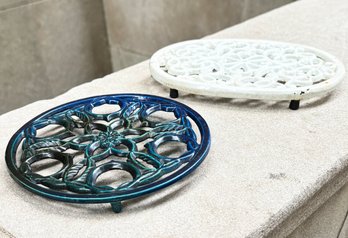 A Pair Of Enameled Cast Iron Trivets