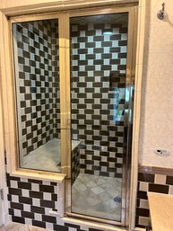 A Polished Nickel Finish Glass Door And Shower Enclosure