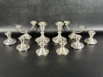 A Collection Of Vintage Candlesticks In Weighted Sterling Silver