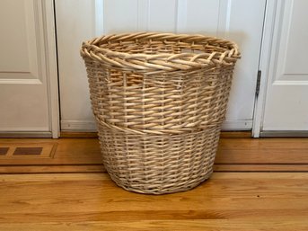 A Large Natural Woven Basket With Open Side Handles