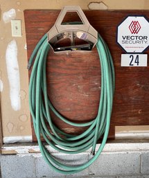 A Garden Hose And Hose Holder