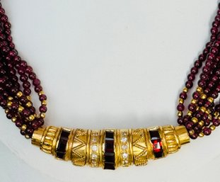 BEAUTIFUL MULTI STRAND GARNET GLASS NECKLACE WITH FANCY GOLD TONE RED & WHITE RHINESTONE CENTER