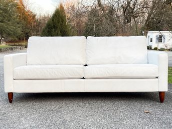 A Sleek Modern Sofa By Crate & Barrel In White Leather