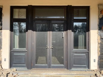 An Exterior Mahogany French Door Pairing With Window Surround And Transoms - Primary