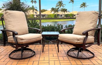 A Pair Of Outdoor Swivel Arm Chairs And A Cocktail Table By Tropitone