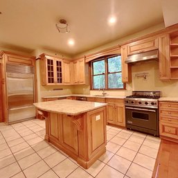 A Charming Wood Kitchen With Granite Counters And Grohe Faucet