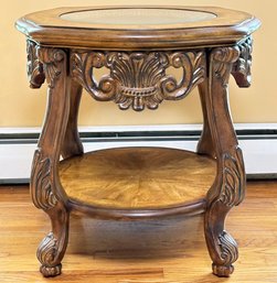 A Carved Wood Side Table With Beveled Glass Top