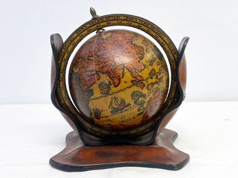 A Decorative Globe On Wood Stand