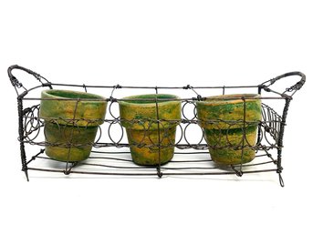 A Wire Basket With Terra Cotta Planters