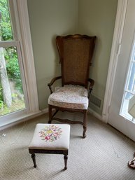 Vintage Caned Back Armchair With Wings And Upholstered Seat And Needlepoint Ottoman