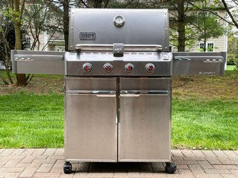 A Weber Genesis Propane Grill And Pair Of Tanks