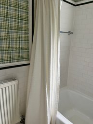 A White Cotton Shower Curtain With A Geometric Embroidered Design