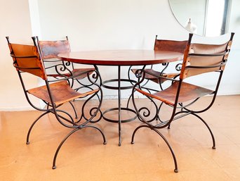 A Wrought Iron Base Dining Table With Wrought Iron And Leather Chairs By Gould & Goodrich For ABC Carpet