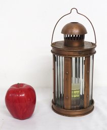 A Henri Bendel Home Copper Finished Prism Lighthouse Candle Lantern