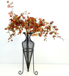 Faux Floral In A Metal Wire Amphora