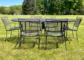 A Vintage Wrought Iron And Mesh Outdoor Dining Table And Set Of 6 Chairs