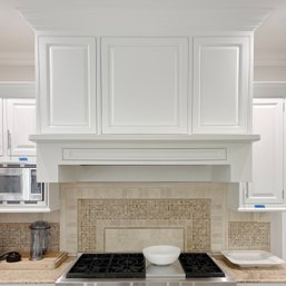 A Dacor Exhaust Hood With Birchcraft Custom Surround