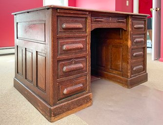 An Early 20th Century Paneled Oak Knee Hole Desk