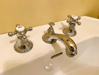 A Cross Handle Three Piece Chrome Faucet And Chrome Bathroom Accessories