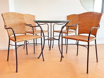 A Glass Top Bistro Table And Set Of 4 Woven And Wrought Iron Chairs By Crate & Barrel