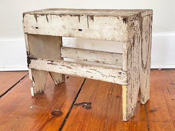 A Rustic Wood Bench Or Footstool