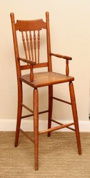 Antique Oak Bannister Baby High Chair With Turned Beaded Spindles And A Cane Seat